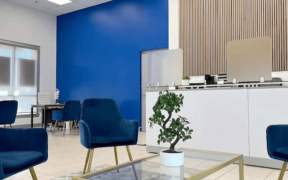 Modern Anytime Capital bank branch interior with blue accent wall and contemporary furniture